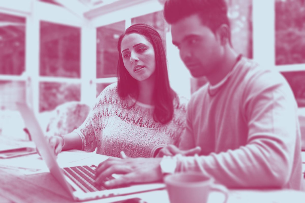 Inclusive Sky_Serious adult woman and man with laptop_iStock_903597188