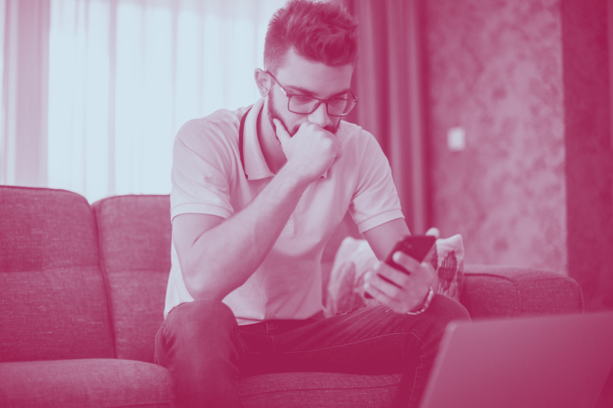 Inclusive sky_serious younger man with phone_iStock_1284992023