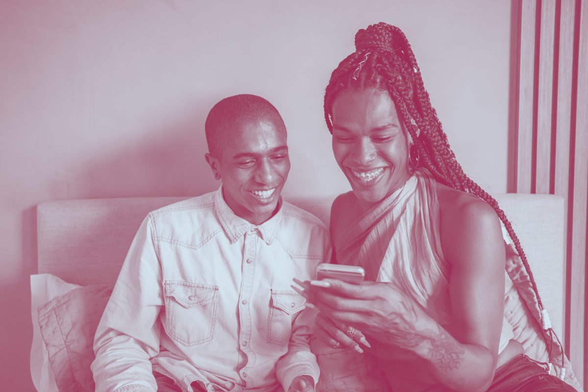 Inclusive_Smiling adults with phone_iStock_1322187044